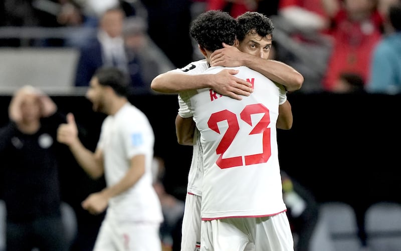 Shojae Khalilzadeh (facing) and Ramin Rezaeian of Iran celebrate at the end of their  match against Egypt, which ended 1-1. Photograph: EPA