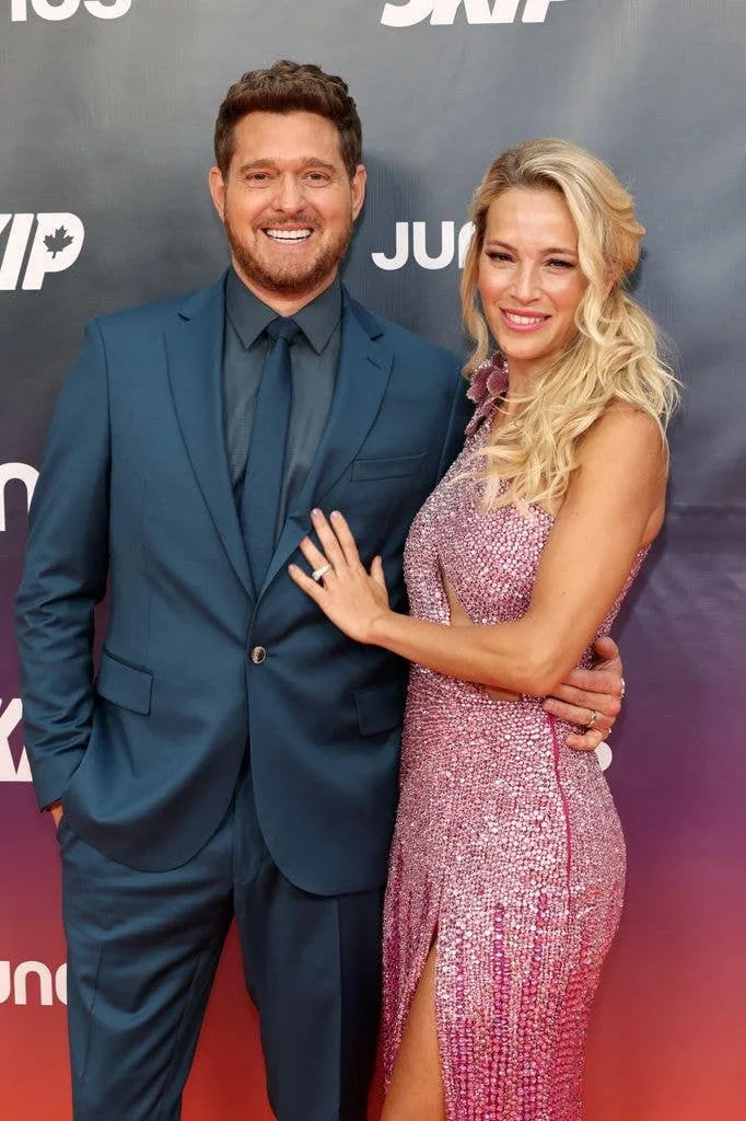 photo of michael buble and wife luisana lopilato on red carpet