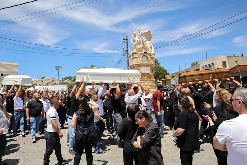 Relatives and friends of a man who was killed along with his son and daughter in an Israeli strike that targeted their car earlier this week in southern Lebanon attend their funeral in the Christian border village of Qlayaa on Wednesday. Photograph: AFP via Getty