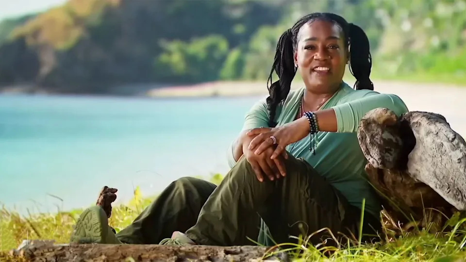  Cirie sits by a rock with a gorgeous view of Fiji in the background for a confessional on Survivor. . 