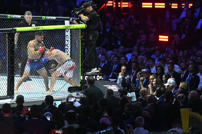 Donald Trump (R) watches the lightweight title bout between Georgia's Ilia Topuria and America's Justin Gaethje. Photograph: SAUL LOEB/AFP/Getty Imagee