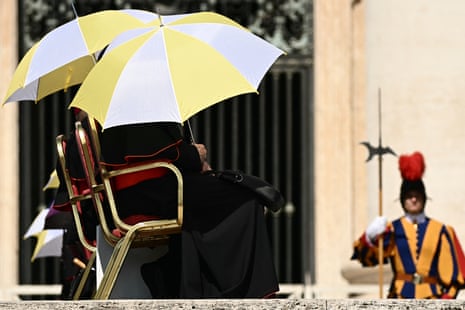 Cardinals shield themselves from the sun with umbrellas during Pope Leo XIV's weekly general audience at St Peter's Square in The Vatican.