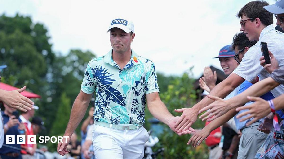 Viktor Hovland of Norway high fives fans while walking towards the first tee box during the final round of the 2026 Travelers Championship