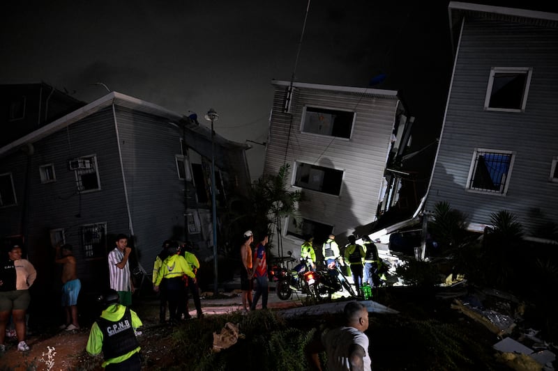 Residents and emergency workers stand near damaged buildings following an earthquake in Catia La Mar, La Guaira state, some 30km northwest of Caracas. Photograph: Federico Parra/AFP via Getty Images