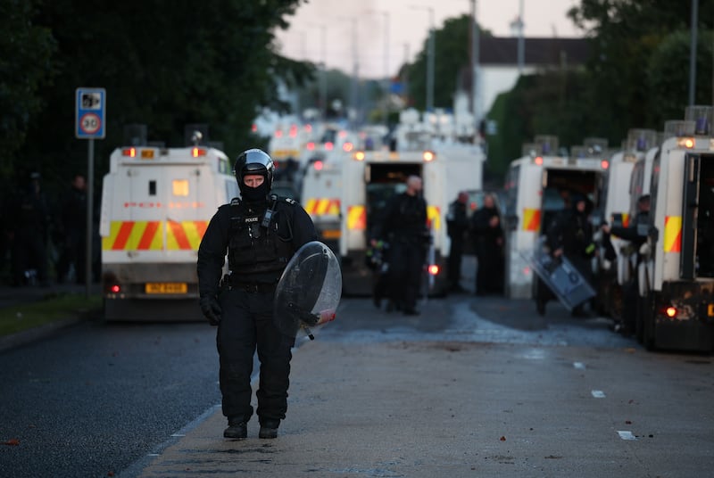 A police officer walks in riot gear on Antrim Road in Newtownabbey, north Belfast, on Wednesday. Photograph: Adam Vaughan/EPA