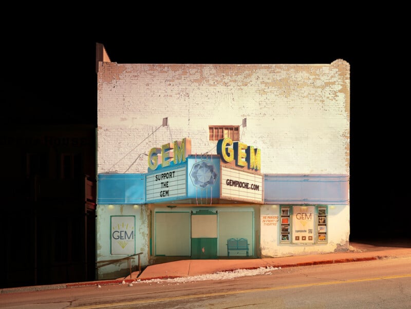 A brightly lit vintage theater called GEM stands on a quiet, sloped street at night. The marquee reads "SUPPORT GEM" and "GEMPORE.COM." The building's paint is faded, and the surrounding area is dark.