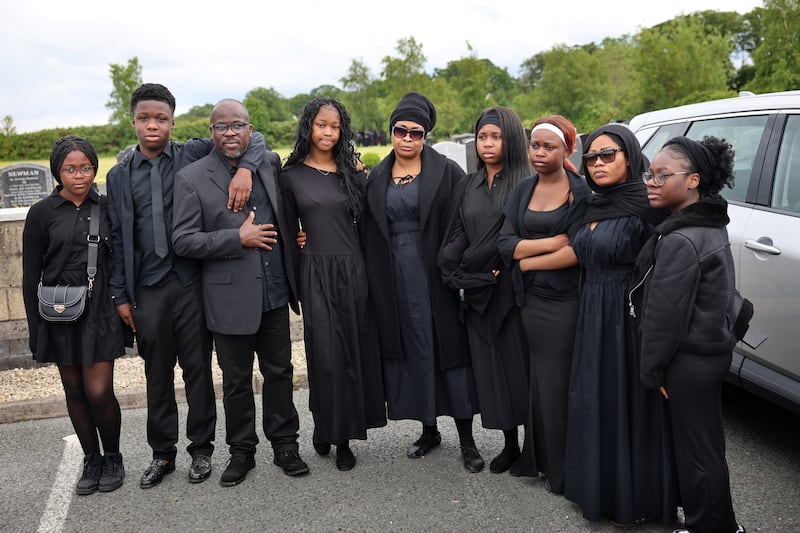 Family gather after the funeral of Qayyum Balogun: Ibrahim Balogun (father), Teslimot, (mother), and Loveth Patrick (stepmother) with siblings including Alimat, Alyah, Ayomide, Tolu, Ganiyu and Gift, at Newtown Cross Lawn Cemetery, Drogheda, Co Louth. Photograph: Dara Mac Dónaill/The Irish Times