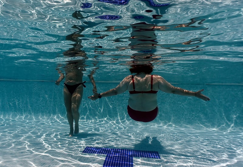 Women cool off in a pool in Madrid, Spain on Wednesday. Photo: Oscar Del Pozo/AFP via Getty Images