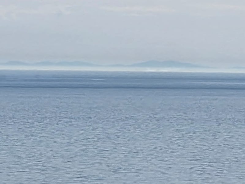 A zoom photograph taken on a Samsung S25 of the Welsh coastline from Killiney Hill. Photograph: Emmet Riordan  