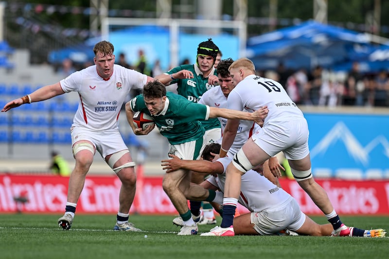 Ireland's Tom Wood is tackled by England's Oliver Spencer. Photograph: Levan Verdzeuli/Inpho