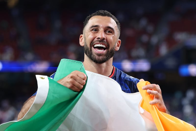 Cape Verde defender Pico Lopes celebrates with an Irish flag after Cape Verde qualified for the World Cup round of 32 with a scoreless draw against Saudi Arabia at Houston Stadium, Texas, on Saturday. Photograph: Michael Steele/Getty Images