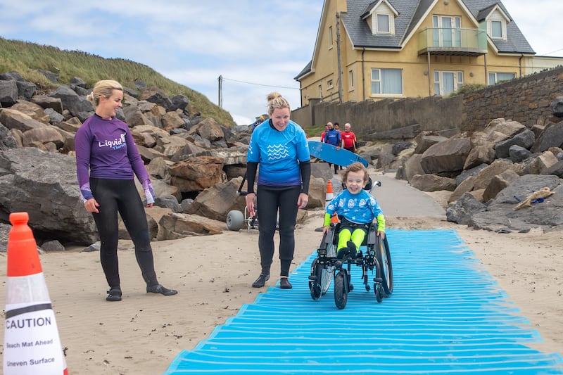 Teddy with his mum Natasha and Occupational Therapist Katie at Rossnowlagh beach, Co Donegal. Photograph: Darragh Gorman