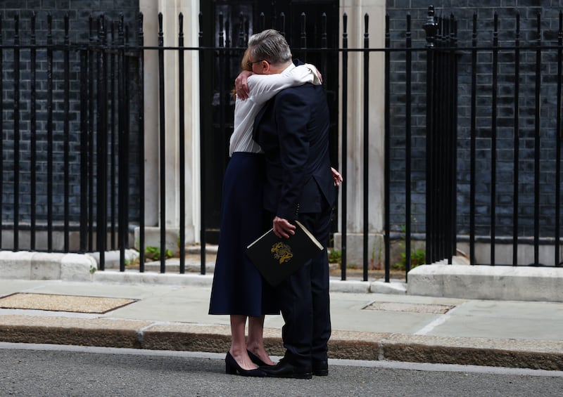 Keir Starmer hugs his wife Victoria after announcing his resignation as UK prime minister. Photograph:  Peter Nicholls/Getty Images