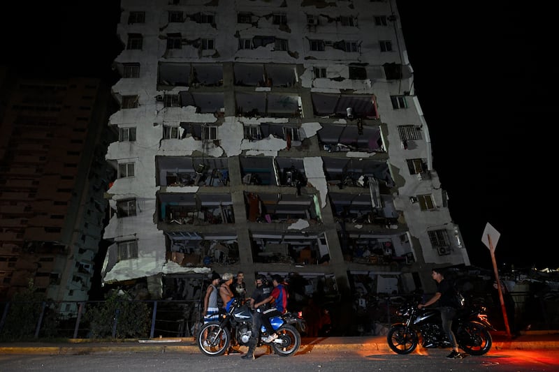 People gather outside a damaged building following an earthquake in Catia La Mar, La Guaira state, some 30km northwest of Caracas. Photograph: Federico Parra / AFP via Getty Images