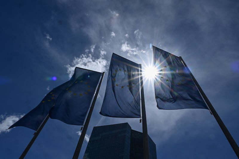 European Union flags flutter in the breeze in front of the headquarters of the European Central Bank's (ECB) headquarters as the sun shines in Frankfurt this morning.  Photo by Kirill KUDRYAVTSEV / AFP via Getty Images