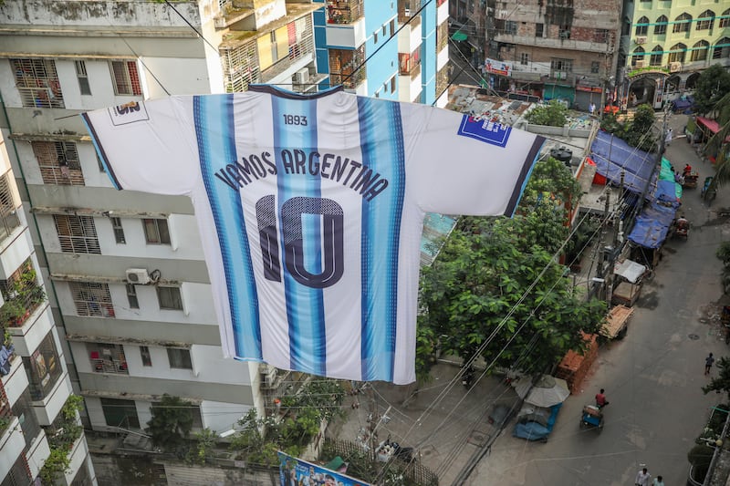 An enormous Argentina jersey hangs over a street in Dhaka, Bangladesh during the World Cup. Photograph: Monirul Alam/European Pressphoto Agency