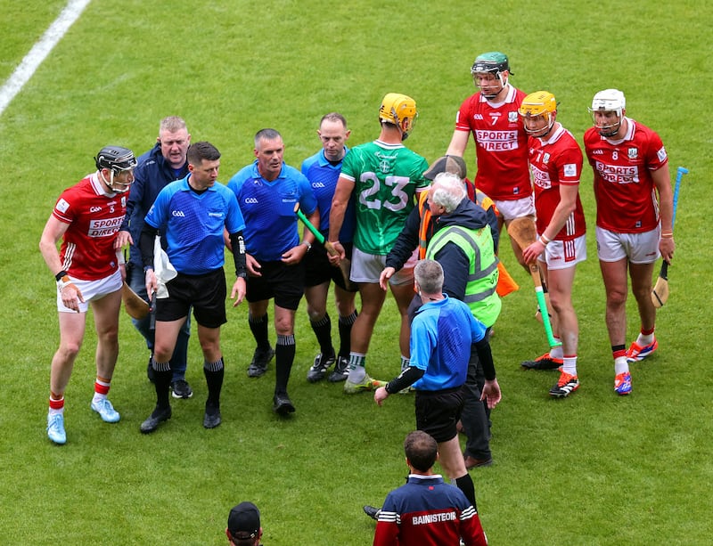 Referee James Owens with Cork players after the final whistle against Limerick. Photograph: Tom O’Hanlon/Inpho