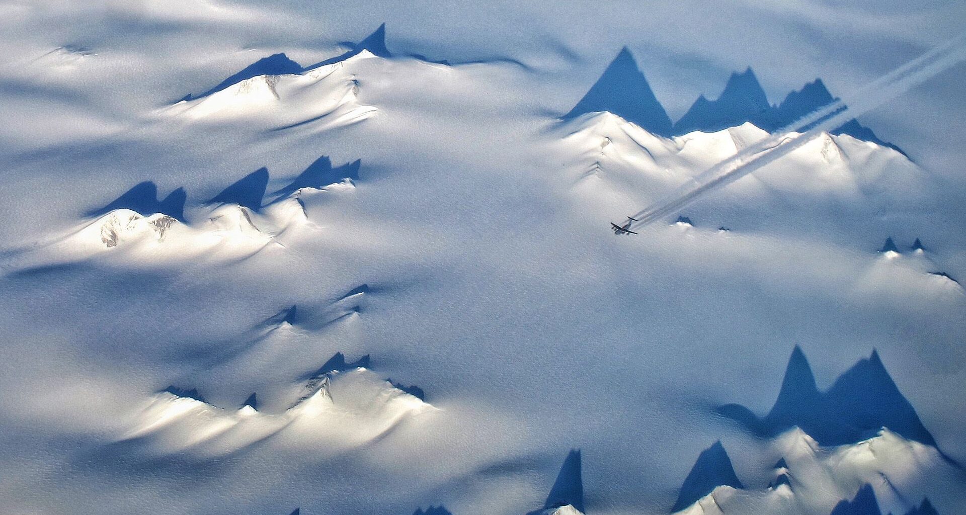 An aerial view of the snowy landscape of Antarctica.