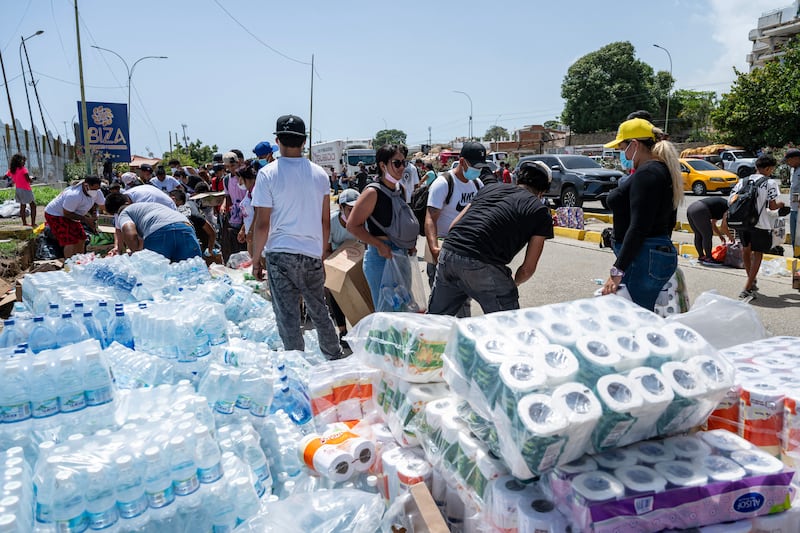 People receive donations in Caraballeda, La Guaira state, Venezuela. Photograph: Miguel Medina/AFP/Getty Images