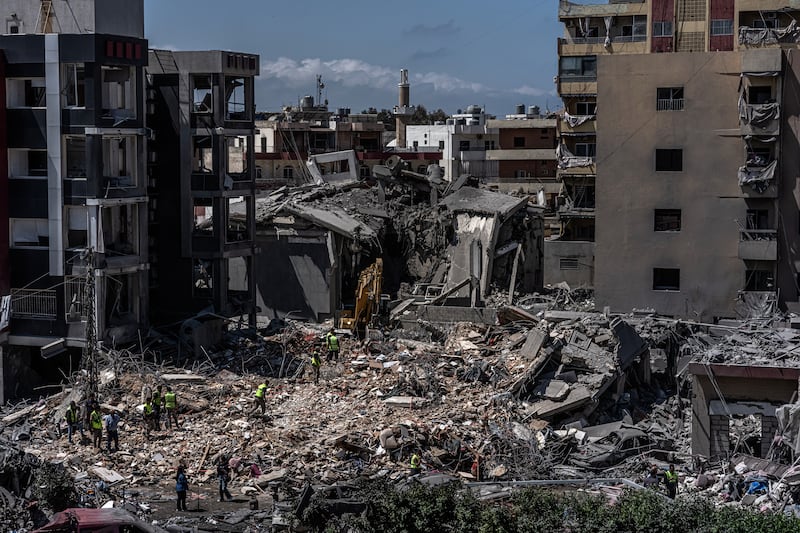 Rescue workers use an excavator as they search for people under the rubble of a building that was hit in an Israeli strike in the southern port city of Tyre on June 2nd. Photograph: Daniel Berehulak/The New York Times
                      