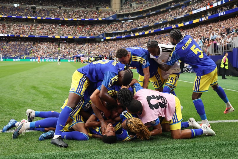 Livano Comenencia is engulfed by celebrating team-mates after equalising for Curaçao against Germany in Sunday's World Cup Group E match in Houston, Texas. Photograph: Alexander Hassenstein/Getty Images