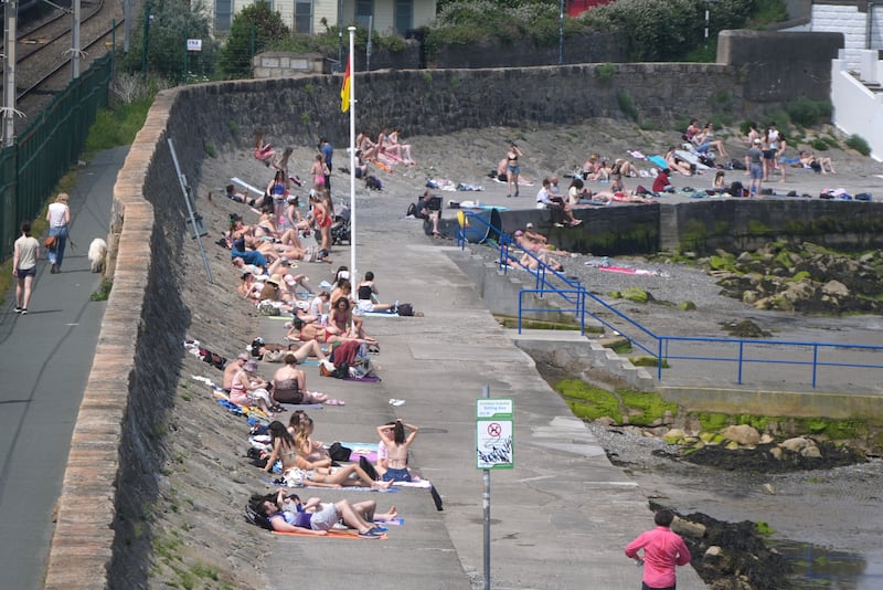 Sunbathers at Seapoint in Dún Laoghaire, Dublin, on Tuesday. Photograph: Niall Carson/PA 

