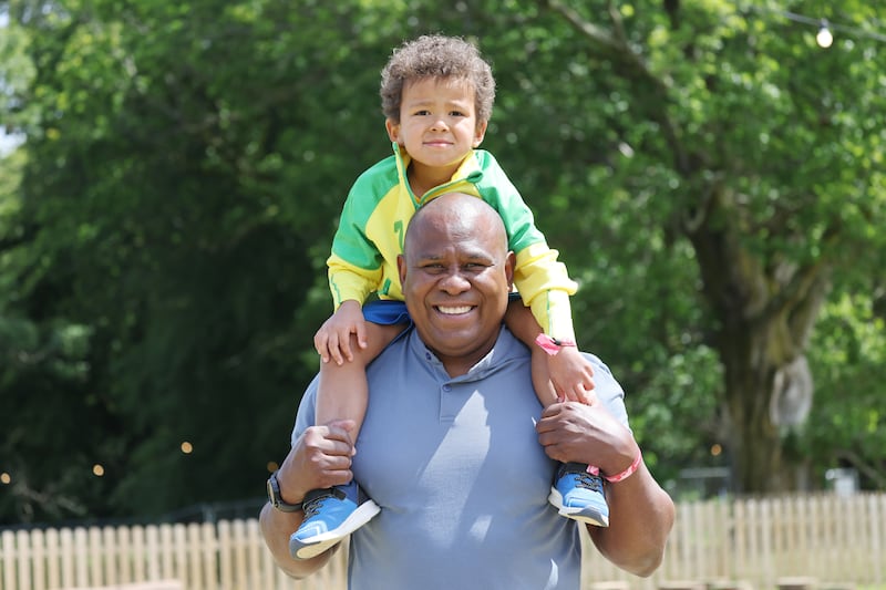 Sansao Maia with his son Kai from Swords, Co Dublin, via Brazil, at the 2026 Beyond the Pale in Glendalough estate, Co Wicklow. Photograph: Alan Betson
