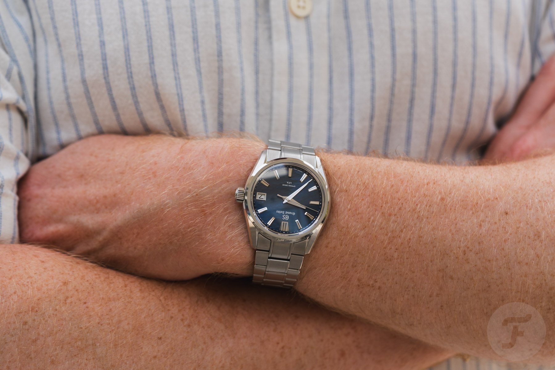 Grand Seiko Evolution 9 Spring Drive U.F.A. SLGB015 on wrist, arms folded