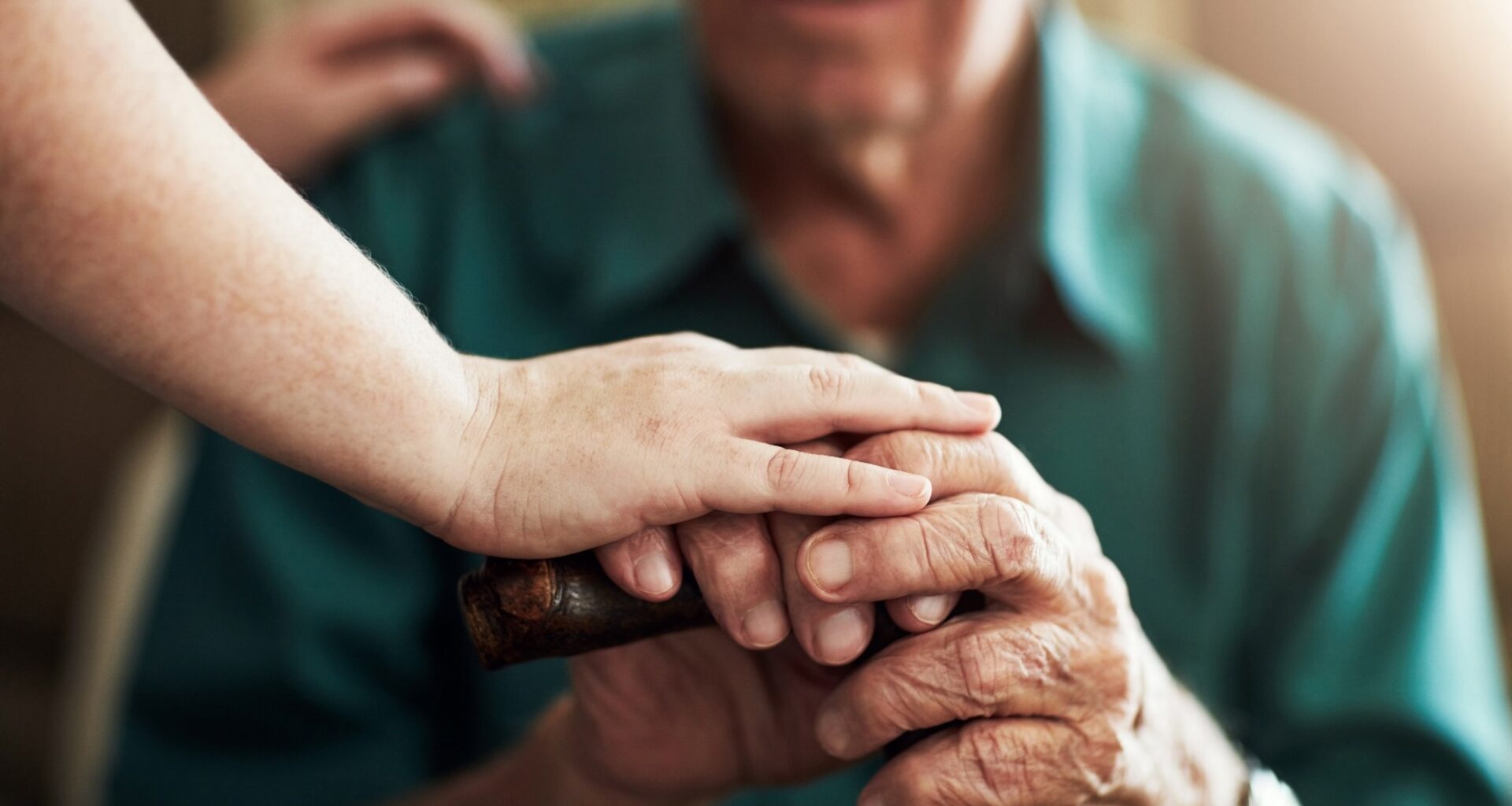 Hands, elderly man and woman in nursing home with support for retirement, assisted living and alzheimer care. Female caregiver, senior patient and touch with kindness for trust, healthcare and help