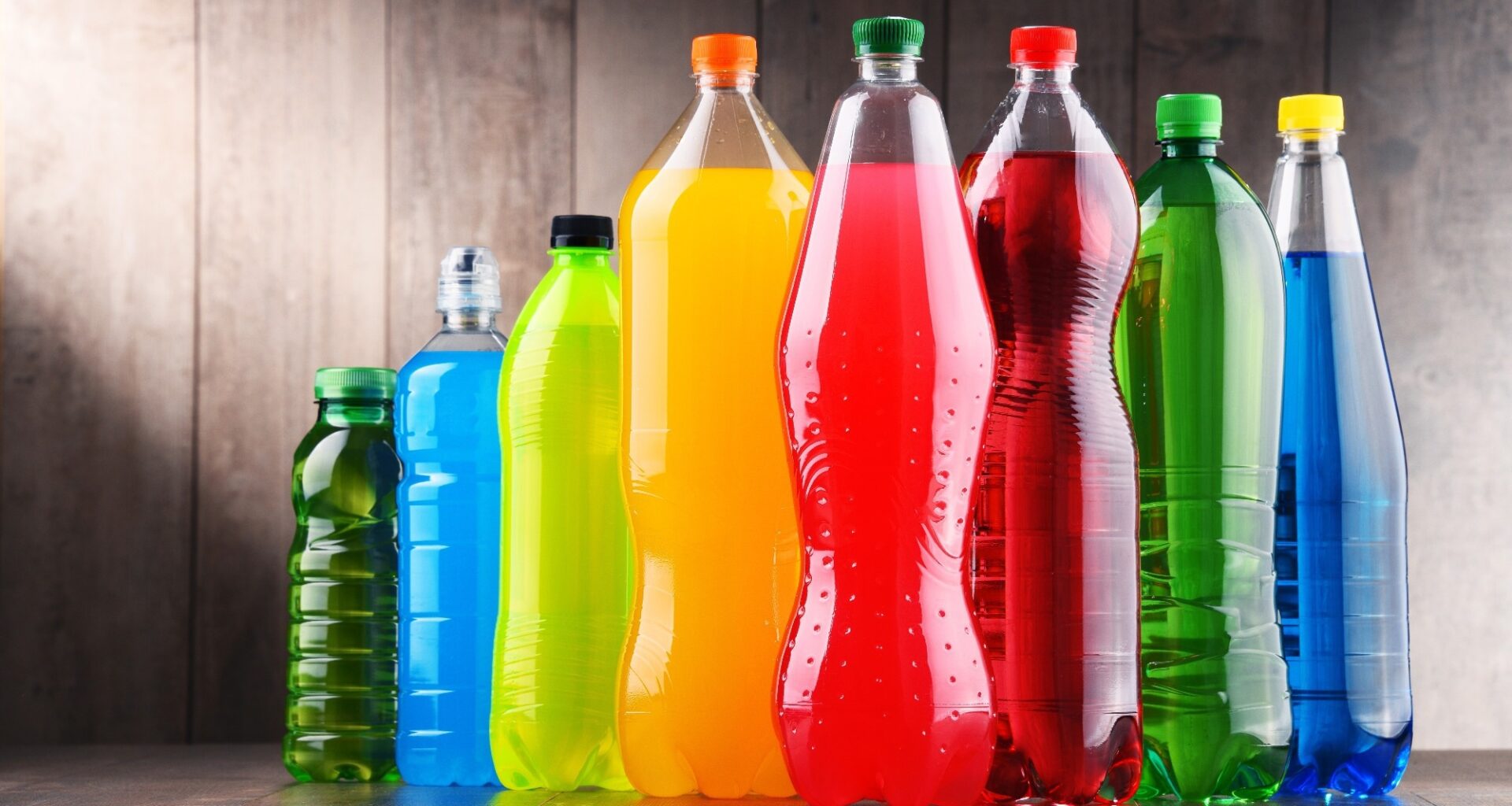 Plastic bottles of assorted carbonated soft drinks in variety of colors