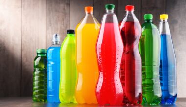 Plastic bottles of assorted carbonated soft drinks in variety of colors