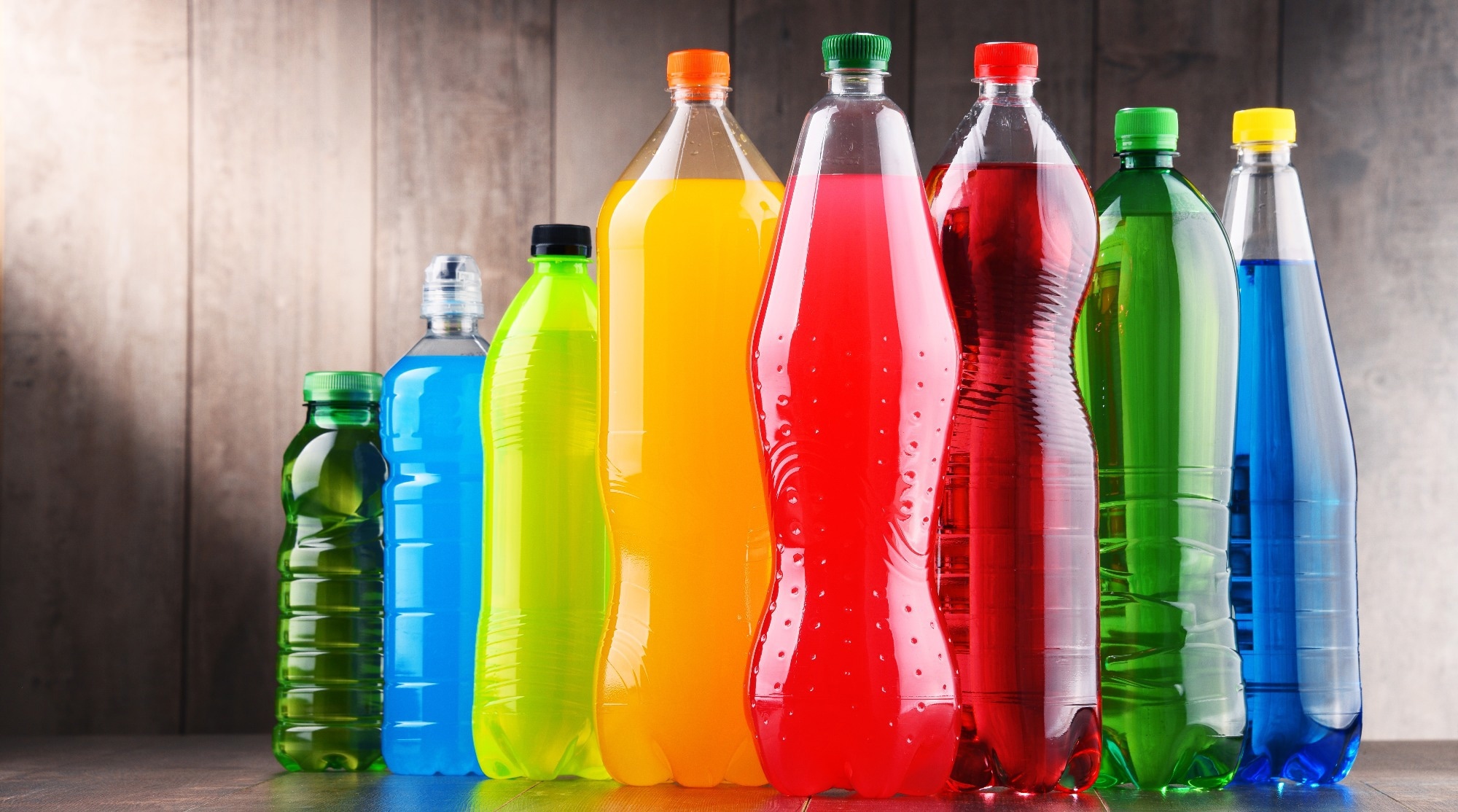 Plastic bottles of assorted carbonated soft drinks in variety of colors