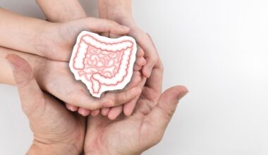 Healthy large intestine holding hand adult and child family. Concept of intestinal disease treatment or colorectal cancer awareness.