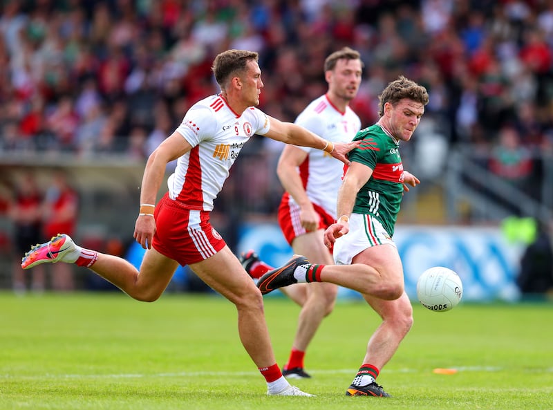 Mayo's Jordan Flynn tries to get his shot away as Conn Kilpatrick of Tyrone closes in. Photograph: Tom O’Hanlon/Inpho