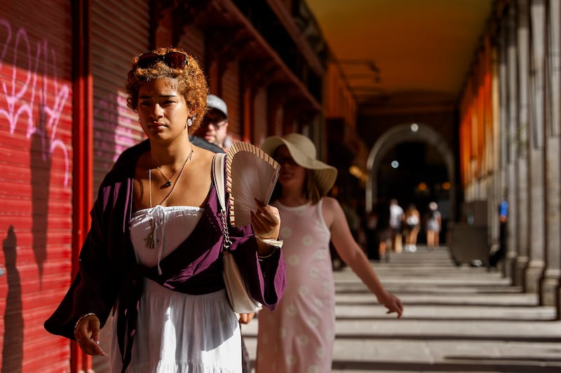 A woman uses a fan at Plaza Mayor in Madrid on June 23th. Photograph: Pablo Blazquez Dominguez/Getty Images