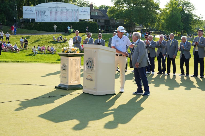 Jack Nicklaus presents the trophy to JT Poston after his winning putt in a playoff during the final round of the the Memorial Tournament at Muirfield Village Golf Club. Photograph: Dylan Buell/Getty