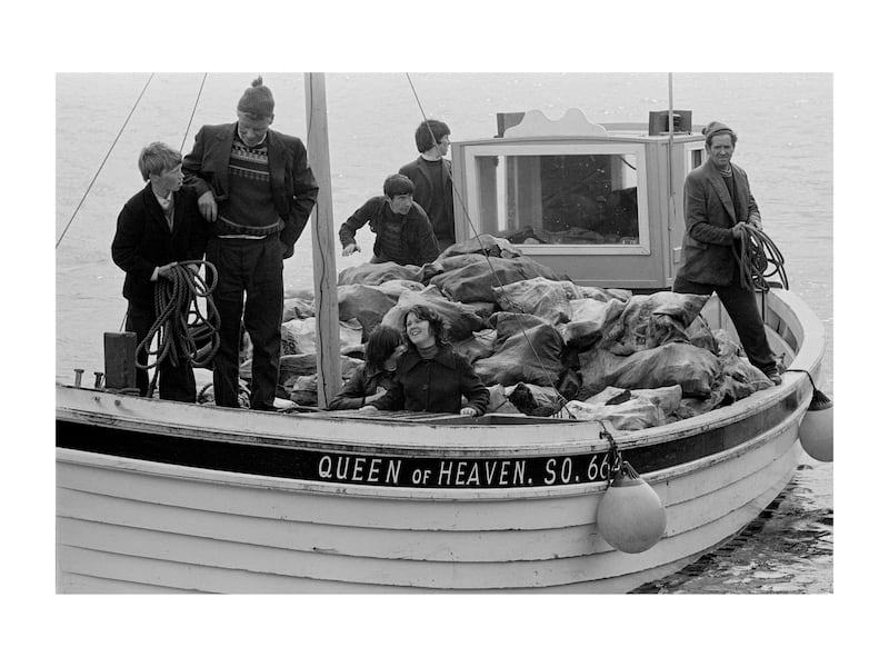 Boats filled with turf for winter fuel arriving with passengers to Tory Island in the 1970s. Photograph: Eric Luke