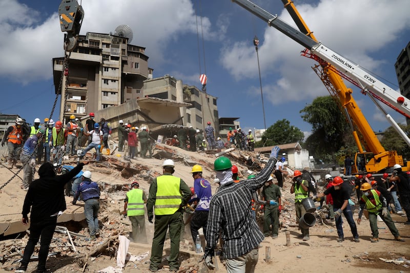 Cranes are used to remove large pieces of debris as part of the search and rescue efforts at the collapsed residential building Rita in the San Bernardino neighbourhood in Caracas on Monday. Photograph: Edilzon Gamez/Getty