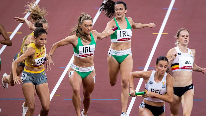 Phil Healy passes the baton to Ireland team-mate Sophie Becker during the final of the mixed 4x400m relay at the Tokyo Olympics. Photograph:  Morgan Treacy/Inpho