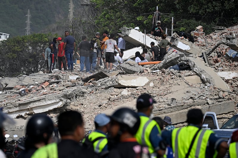 Volunteers searchthrough the rubble in a collapsed building in Caraballeda, La Guaira state. Photograph: Federico Parra/AFP/Getty Images