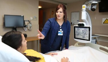 Nurse performs neurologic assessment on patient