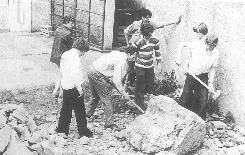 Adam Clayton (far left) with fellow students helping a staff member to clear an area in the grounds of St Columba's College in 1975 for a future arts and crafts complex. Photograph: St Columba's College