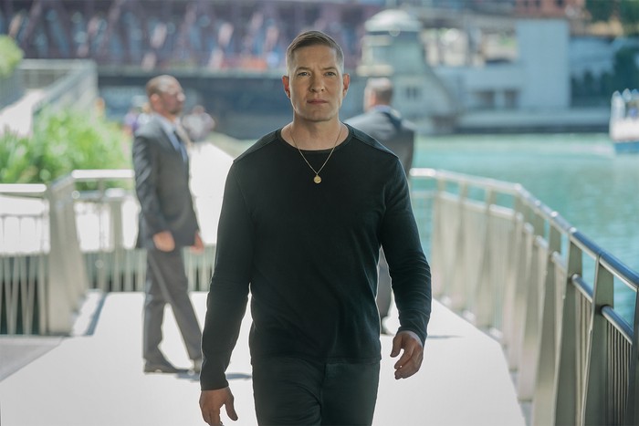 Power Book IV: Force Season 2 2022 Joseph Sikora as Tommy Egan in Power Book IV: Force season 2 wearing a dark outfit, walking on a bridge