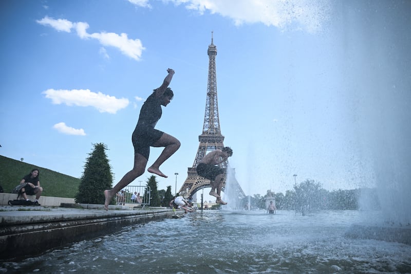 People jump in the Trocadero fountain near the Eiffel Tower. Photograph: Julien de Rosa/AFP via Getty Images