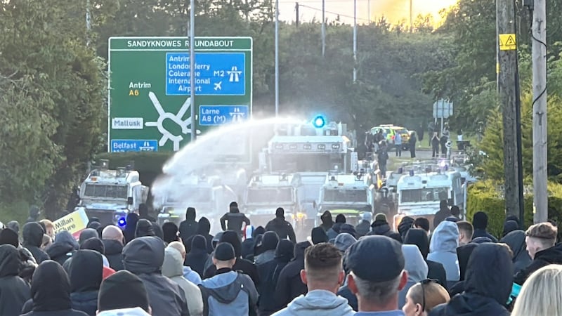 A water cannon is fired towards protesters on Antrim Road, at the Sandyknowes roundabout in Newtownabbey on Wednesday. Photograph: /PA Wire 