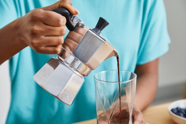Portrait of a cute and happy young black girl in the kitchen, early bird morning routine, drinking coffee, representing positive attitude and a healthy lifestyle, an image with a large copy space