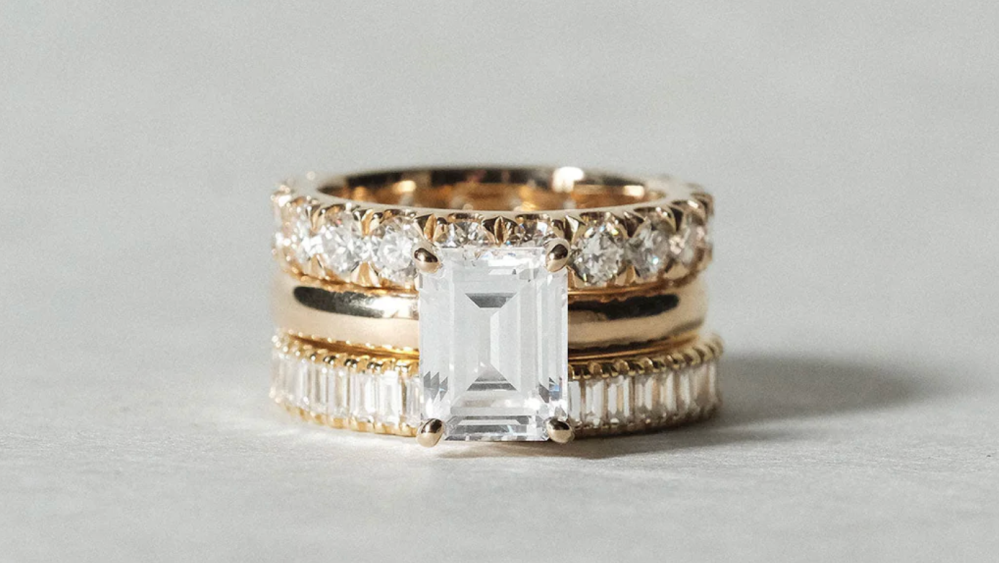 an engagement ring with multiple diamond wedding bands layered