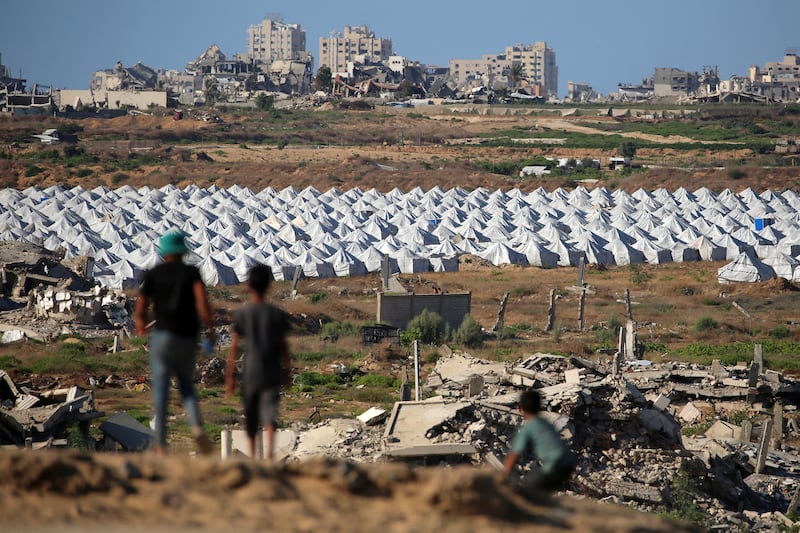 Children stand along a promontory overlooking shelters for people displaced by war, at the Nuseirat camp for Palestinian refugees in the central Gaza Strip on June 19th. Photograph: Eyad Baba/AFP via Getty
