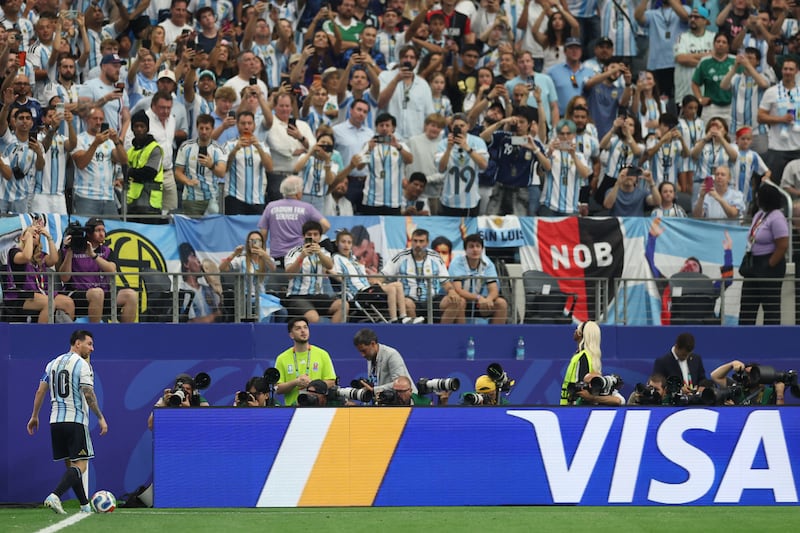 Lionel Messi of Argentina taking a corner kick while fans attempt to take photographs during the Fifa World Cup 2026 Group J match between Argentina and Austria at Dallas Stadium on June 22, 2026 in Arlington, Texas. Photograph: Michael Steele/Getty Images