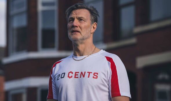 Man standing in the street wearing a football shirt Man standing in the street wearing a football shirt
